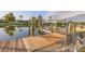 View of a wooden dock featuring pilings and bench seating over the water at 508 65Th St, Holmes Beach, FL 34217