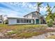 Exterior of a two-story home featuring a sunroom and outdoor staircase at 508 65Th St, Holmes Beach, FL 34217