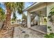 Exterior view of house with a large palm tree, adjacent to boat dock and canal at 508 65Th St, Holmes Beach, FL 34217