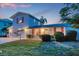 Charming two-story home with pink shutters, mature landscaping, and a well-manicured lawn at 508 65Th St, Holmes Beach, FL 34217