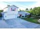 Charming single-Gathering home with a two car garage, neat landscaping, and eye-catching pink shutters at 508 65Th St, Holmes Beach, FL 34217