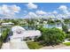 Exterior elevation of a two-story home with a lush yard, a two-car garage, and waterfront views at 508 65Th St, Holmes Beach, FL 34217