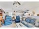 Spacious living room boasts cozy seating, a ceiling fan, and bright natural light at 508 65Th St, Holmes Beach, FL 34217
