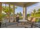 Relaxing outdoor patio with comfortable seating area overlooking lush greenery and waterfront canal at 508 65Th St, Holmes Beach, FL 34217