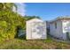 Exterior view of the property featuring a white storage shed in the backyard with green grass at 508 65Th St, Holmes Beach, FL 34217
