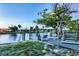 Gorgeous waterfront view with a dock and chairs, perfect for relaxing and enjoying the outdoors at 508 65Th St, Holmes Beach, FL 34217