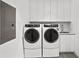 Modern laundry room with washer, dryer and cabinets at 2912 W Santiago St # 2004, Tampa, FL 33629