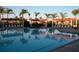 Resort-style pool with shaded seating areas and palm trees at 4271 Cascade Falls Dr, Sarasota, FL 34243