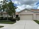 Tan, two-car garage villa with lush landscaping at 4271 Cascade Falls Dr, Sarasota, FL 34243