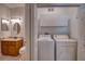 Well-equipped laundry room with washer, dryer, and cabinets at 4271 Cascade Falls Dr, Sarasota, FL 34243