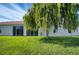 Landscaped backyard with a large tree providing shade at 4271 Cascade Falls Dr, Sarasota, FL 34243