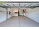 Spacious two-car garage with painted floor and extra storage at 4271 Cascade Falls Dr, Sarasota, FL 34243
