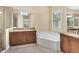 Elegant bathroom with double vanity, soaking tub, and shower at 14215 Kinglet Ter, Lakewood Ranch, FL 34202