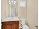 Well-appointed powder room with wood vanity and updated fixtures at 14215 Kinglet Ter, Lakewood Ranch, FL 34202