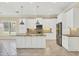 Modern kitchen with white cabinets, granite island, and stainless steel appliances at 14215 Kinglet Ter, Lakewood Ranch, FL 34202