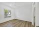 Light and airy bedroom with wood floors and window shutters at 14215 Kinglet Ter, Lakewood Ranch, FL 34202