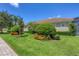 Landscaped backyard with lush greenery and manicured lawn at 14215 Kinglet Ter, Lakewood Ranch, FL 34202