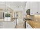 Kitchen with stainless steel appliances, granite countertops, and an island overlooking the pool at 14215 Kinglet Ter, Lakewood Ranch, FL 34202