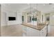 White kitchen with granite island and built-in shelving offers pool views at 14215 Kinglet Ter, Lakewood Ranch, FL 34202