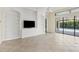 Living room with built-in shelving and access to the pool area at 14215 Kinglet Ter, Lakewood Ranch, FL 34202