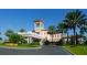 Grand clubhouse entrance with palm trees and landscaping at 14215 Kinglet Ter, Lakewood Ranch, FL 34202