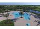 Aerial view of resort-style pool with lounge chairs and umbrellas at 14215 Kinglet Ter, Lakewood Ranch, FL 34202