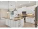 Bright kitchen features white cabinetry, granite countertops, and a large island at 14215 Kinglet Ter, Lakewood Ranch, FL 34202
