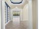 Elegant entry hall with high ceilings, built-in shelving, and views to the pool at 14215 Kinglet Ter, Lakewood Ranch, FL 34202