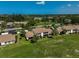 Aerial view of community with lush landscaping, tennis courts, and pool at 684 Bird Bay W Dr # 132, Venice, FL 34285