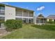 Two-story house with a large grassy backyard and screened balcony at 684 Bird Bay W Dr # 132, Venice, FL 34285
