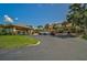 Inviting community entrance with covered walkway and landscaping at 684 Bird Bay W Dr # 132, Venice, FL 34285