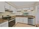 Kitchen with granite countertops, white cabinets, stainless steel appliances at 684 Bird Bay W Dr # 132, Venice, FL 34285