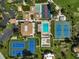 Aerial view showing tennis courts, pool, and clubhouse at 684 Bird Bay W Dr # 132, Venice, FL 34285