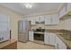 Well-equipped kitchen featuring stainless steel appliances and granite countertops at 684 Bird Bay W Dr # 132, Venice, FL 34285