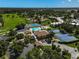 Community clubhouse with pool, tennis courts, and ample parking at 684 Bird Bay W Dr # 132, Venice, FL 34285