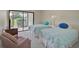 Bedroom with two twin beds and sliding door to patio at 684 Bird Bay W Dr # 132, Venice, FL 34285