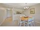 Charming dining room with a round table and chairs, open to the kitchen at 684 Bird Bay W Dr # 132, Venice, FL 34285