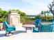 Outdoor patio with fireplace and seating area, overlooking the water at 815 Tropical Cir, Sarasota, FL 34242