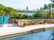 Inviting pool area with brick wall and lush landscaping at 815 Tropical Cir, Sarasota, FL 34242