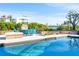 Inviting pool area with fireplace and patio furniture at 815 Tropical Cir, Sarasota, FL 34242