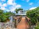 Wooden dock with bridge leading to a canal, offering serene waterfront views at 815 Tropical Cir, Sarasota, FL 34242
