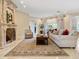 Spacious living room featuring a fireplace, ornate mantel, and comfortable seating at 815 Tropical Cir, Sarasota, FL 34242