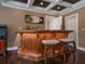 Custom wet bar with marble countertop and wooden cabinetry at 815 Tropical Cir, Sarasota, FL 34242