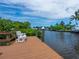 Relaxing waterfront dock with a white bench, perfect for enjoying the view at 815 Tropical Cir, Sarasota, FL 34242