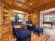 Cozy library with built-in bookshelves and comfortable armchairs at 815 Tropical Cir, Sarasota, FL 34242