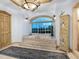 Spa-like bathroom with a large soaking tub, elegant chandelier and big window at 815 Tropical Cir, Sarasota, FL 34242