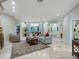 Bright living room with hardwood floors, a cozy seating area, and access to other rooms at 815 Tropical Cir, Sarasota, FL 34242