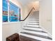 Elegant staircase with dark wood treads and white risers, featuring a Venetian-themed window at 815 Tropical Cir, Sarasota, FL 34242