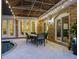 Covered patio with dining table and string lights, adjacent to pool at 815 Tropical Cir, Sarasota, FL 34242