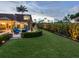 Spacious backyard patio with seating area, fire pit, and lush landscaping at 815 Tropical Cir, Sarasota, FL 34242